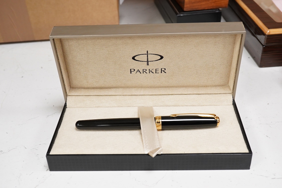 A group of five fountain pens and ballpoint pens